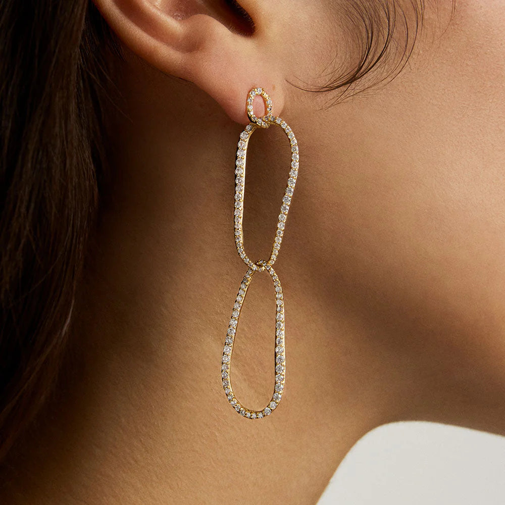 Woman wearing golden drop earrings