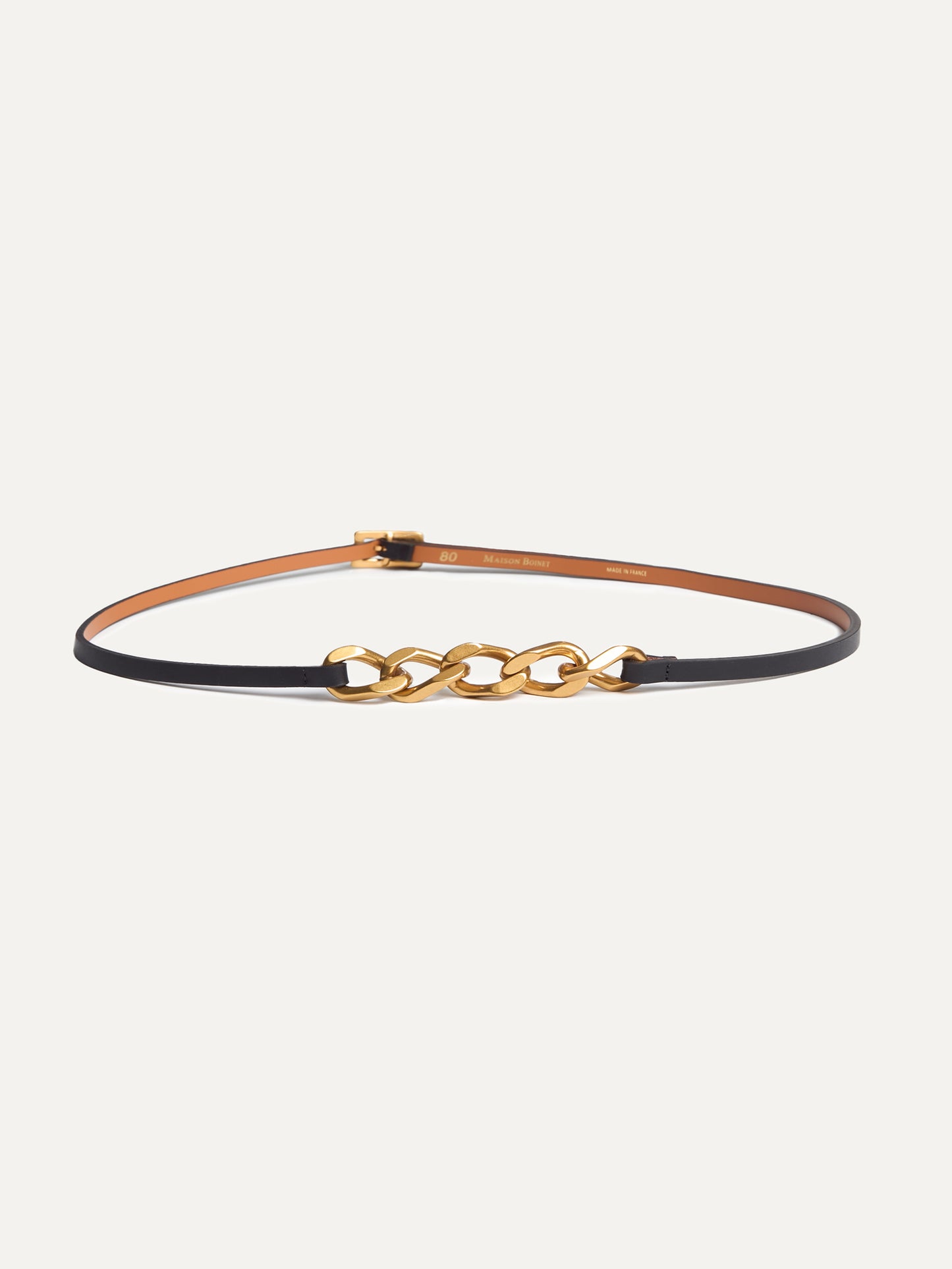 Black and gold Gabrielle Belt by Maison Bonnet crafted in supple nappa cowhide leather with split leather lining, featuring a striking gold-finish zamac buckle and chain.