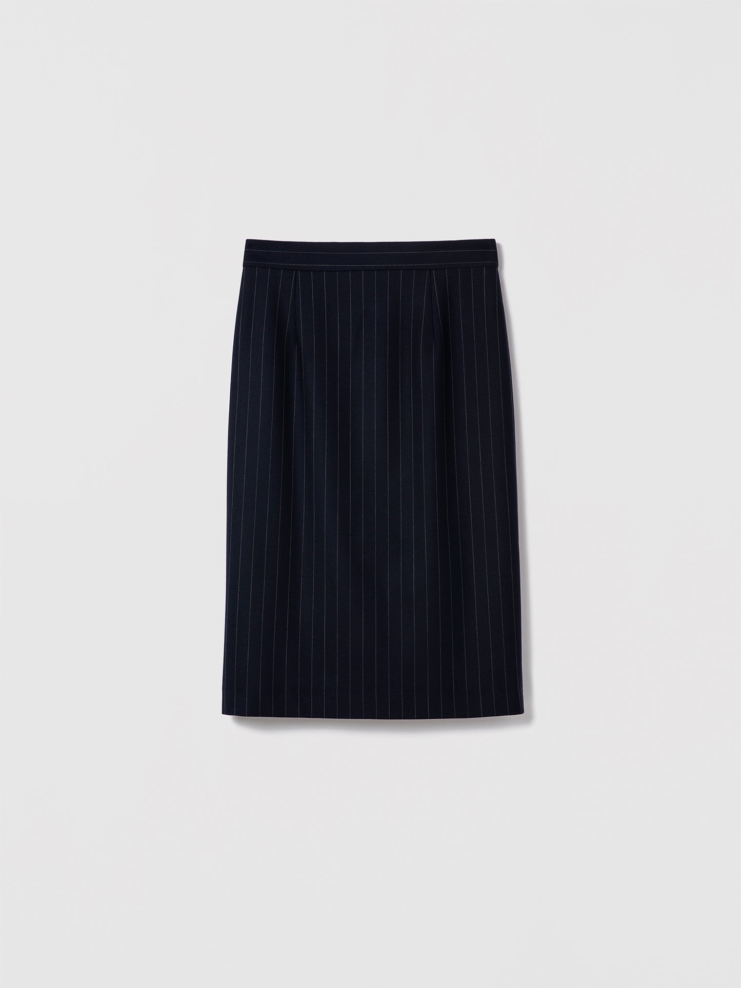 Judith & Charles navy pinstripe pencil skirt with clean waist, invisible back zipper, and back slit. Fully lined, made in Canada in stretch suiting fabric.