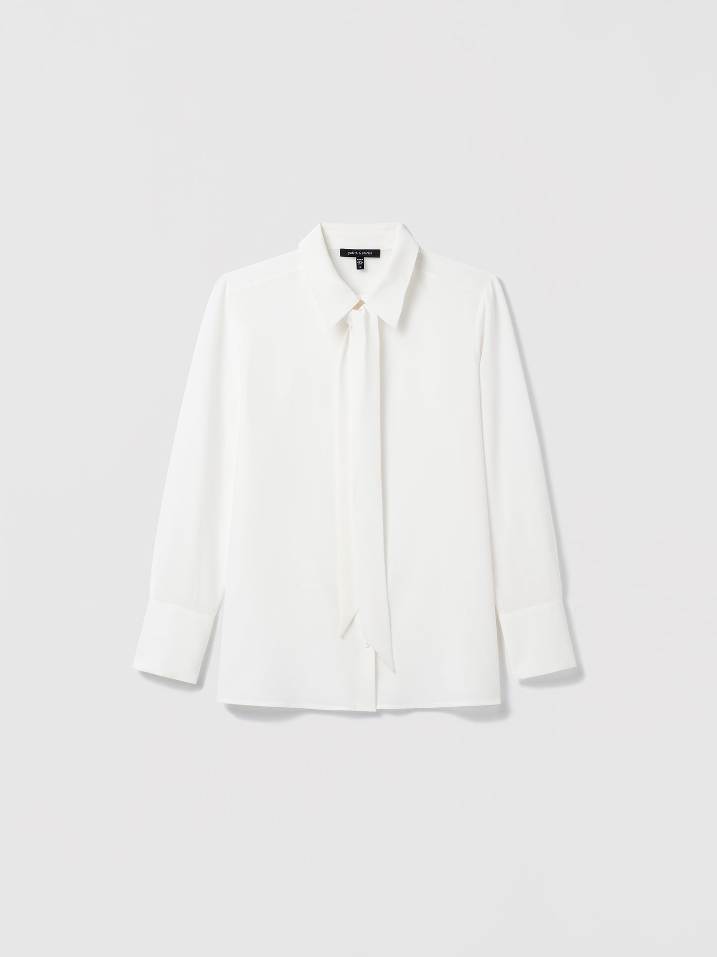 Silk white blouse with a removable self tie and button closure shown in a clean, lightweight silhouette.