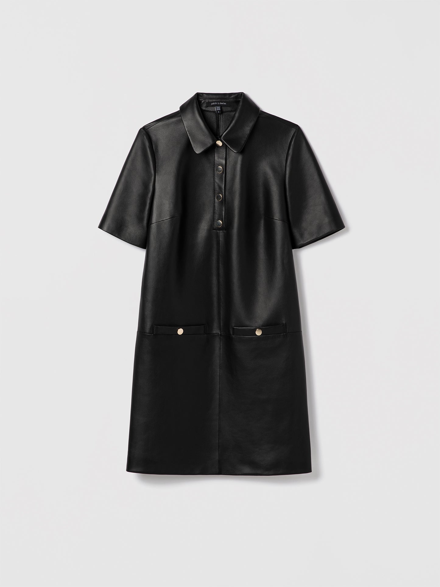 Black leather short sleeve polo dress with spread collar and welt pockets
