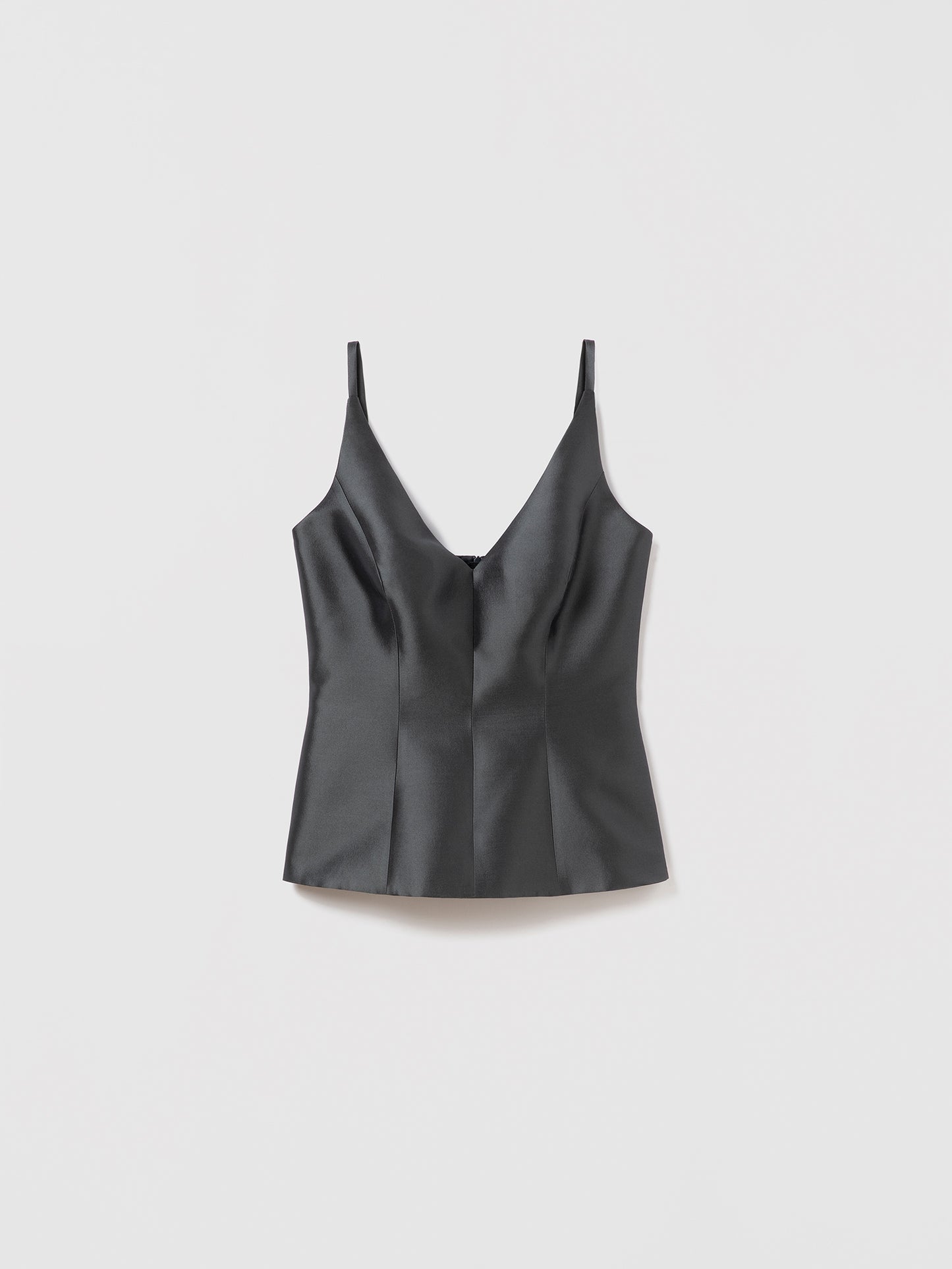 Flat lay of fitted peplum top in anthracite silk-wool blend with V-neck and straps, featuring invisible back zipper