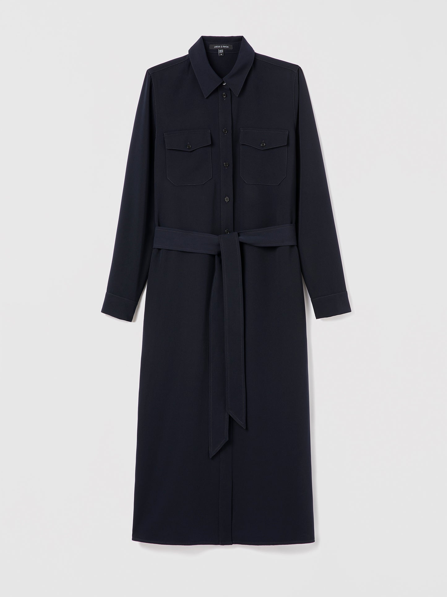 Judith & Charles navy long sleeve shirt dress with chest flap pockets, gold button closure, self-tie belt, and buttoned cuffs.