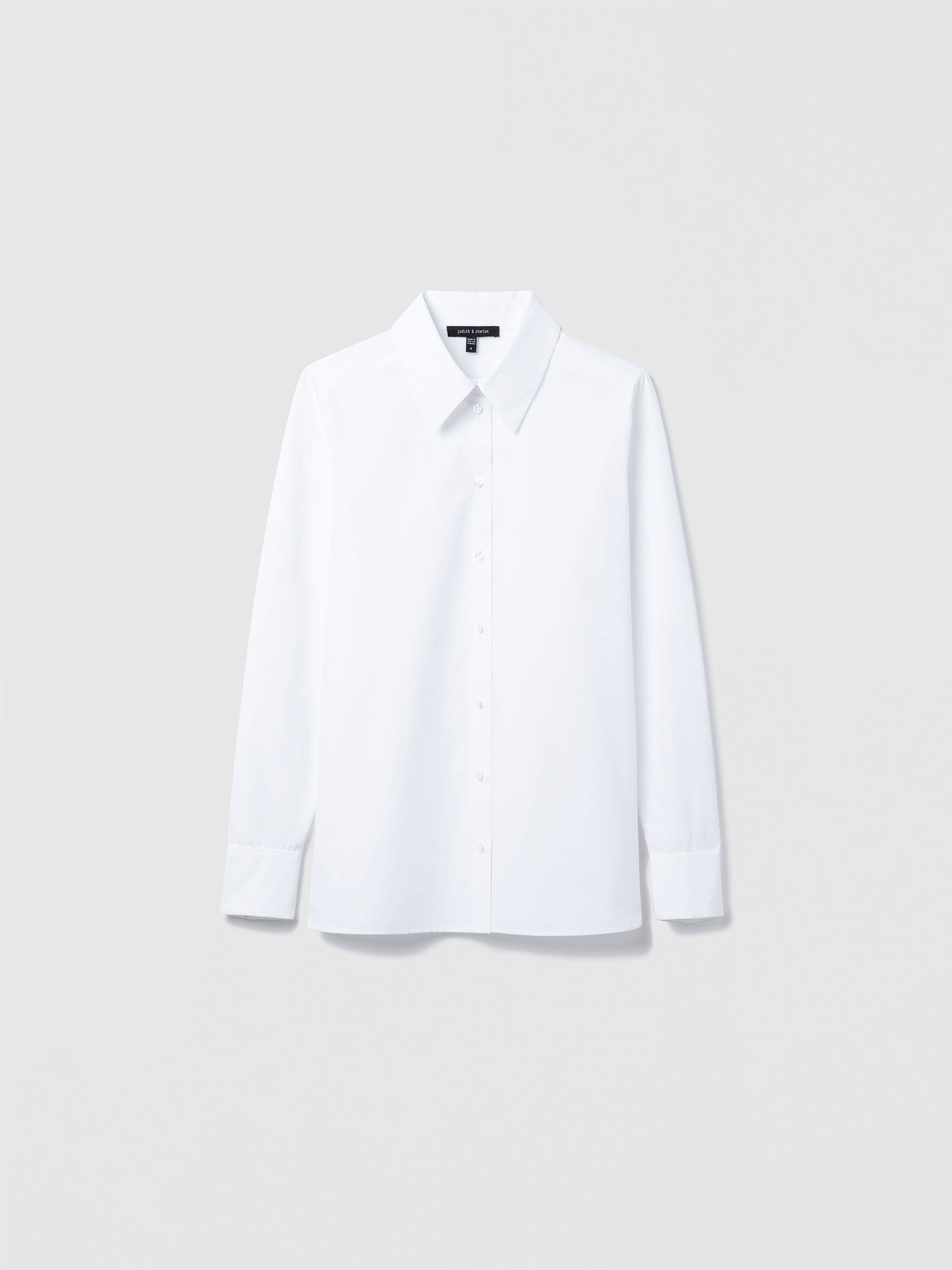 Judith & Charles long sleeve white cotton blouse with spread collar and button closure, semi-fitted and unlined, made in Canada.