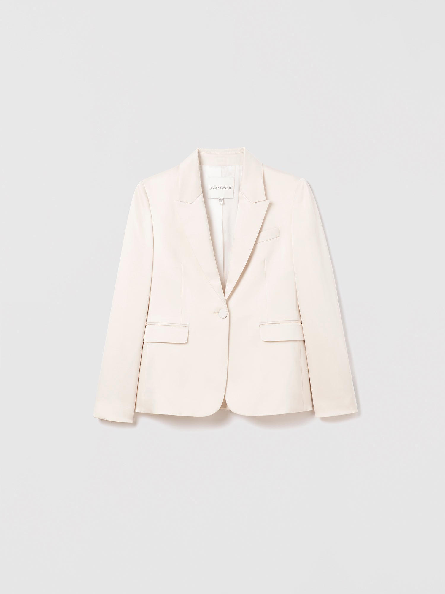 Flat lay of classic fit satin jacket in cream with peak lapel, flap and chest pockets, and back vent