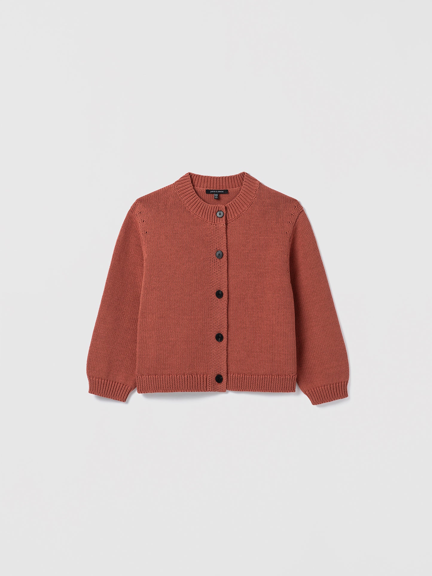Terracotta knitted cardigan on a light gray background