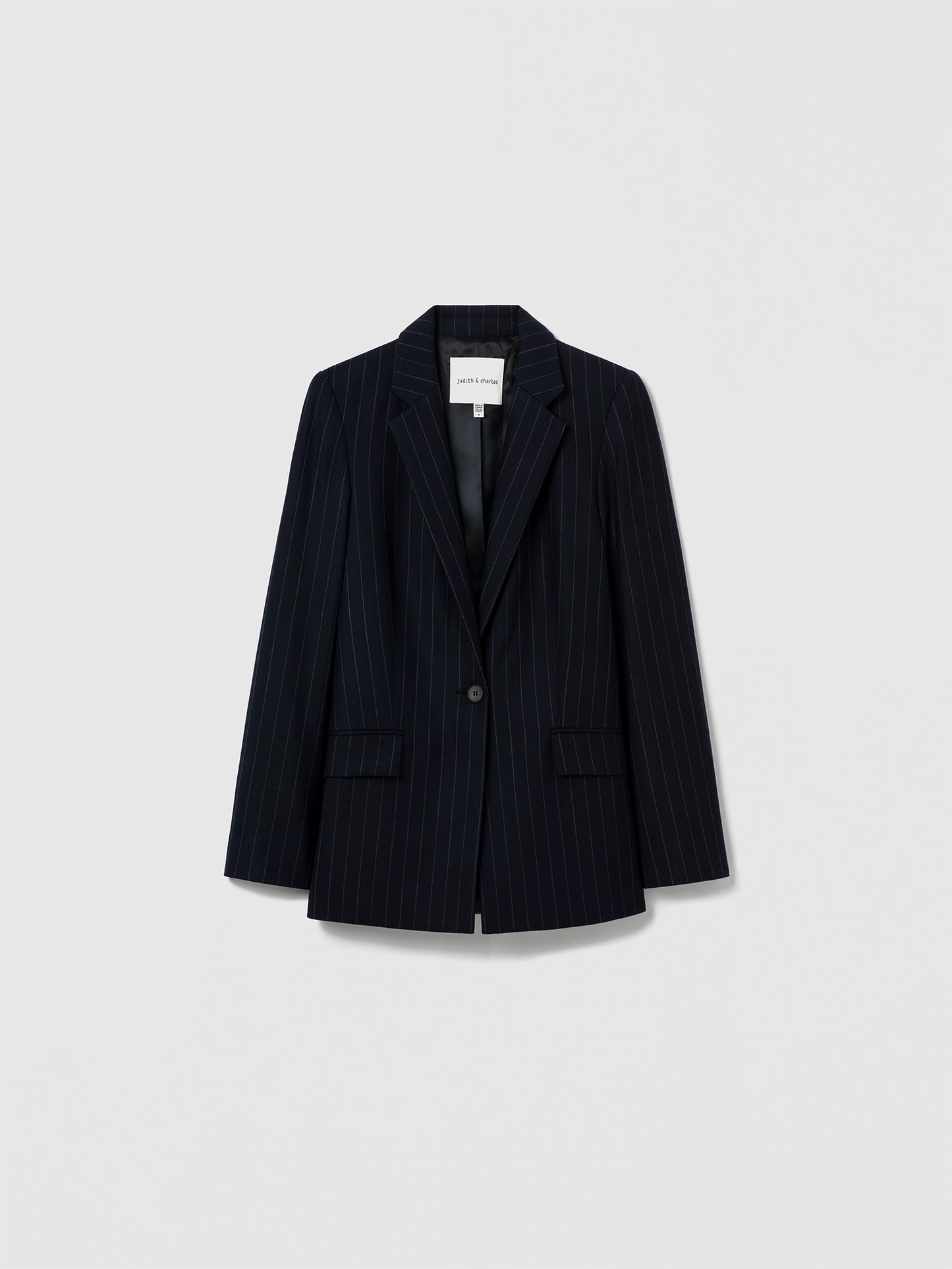 Judith & Charles navy pinstripe single-breasted blazer with notch lapel and button closure, made in Canada from virgin wool blend and fully lined in viscose.