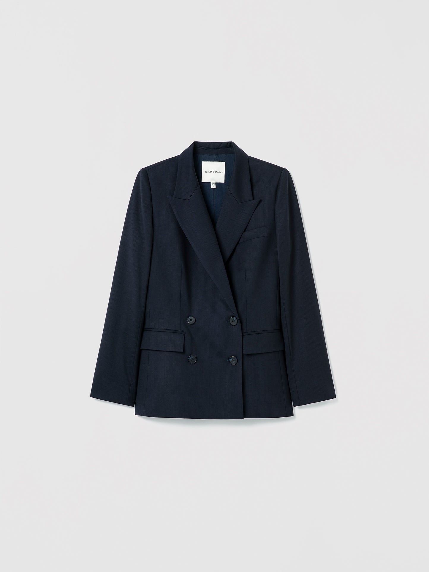 Navy blazer on a light gray background