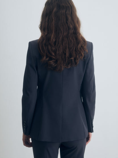 Person wearing a dark gray suit on a white background