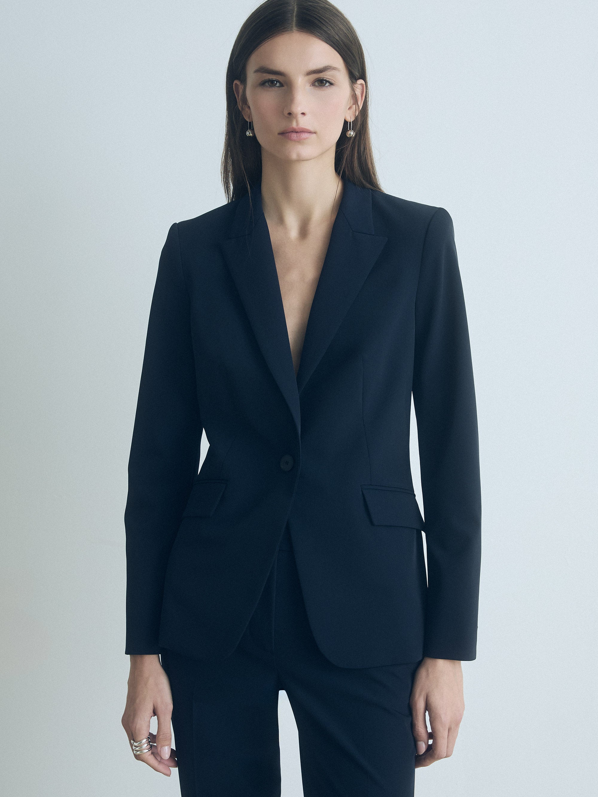 Woman wearing a moonlight jacket against a light gray background