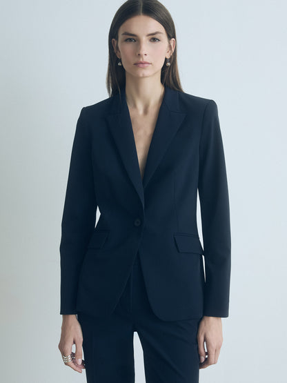 Woman wearing a moonlight jacket against a light gray background