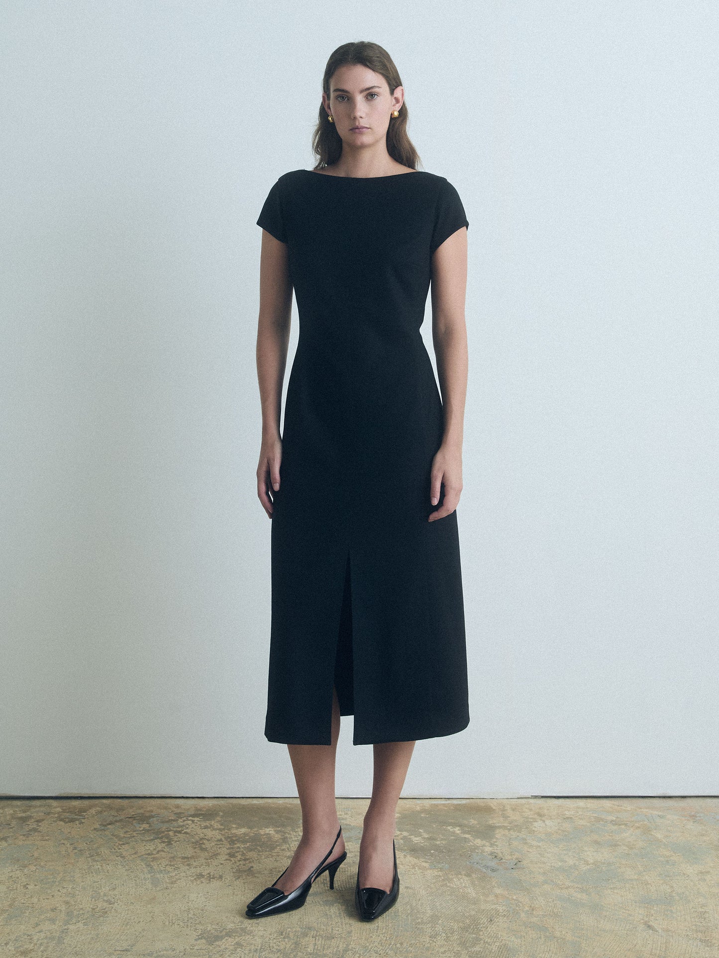 Black wool-blend boat neck dress with front slit and invisible back zipper, fully lined, made in Canada from Italian fabric by Judith & Charles.