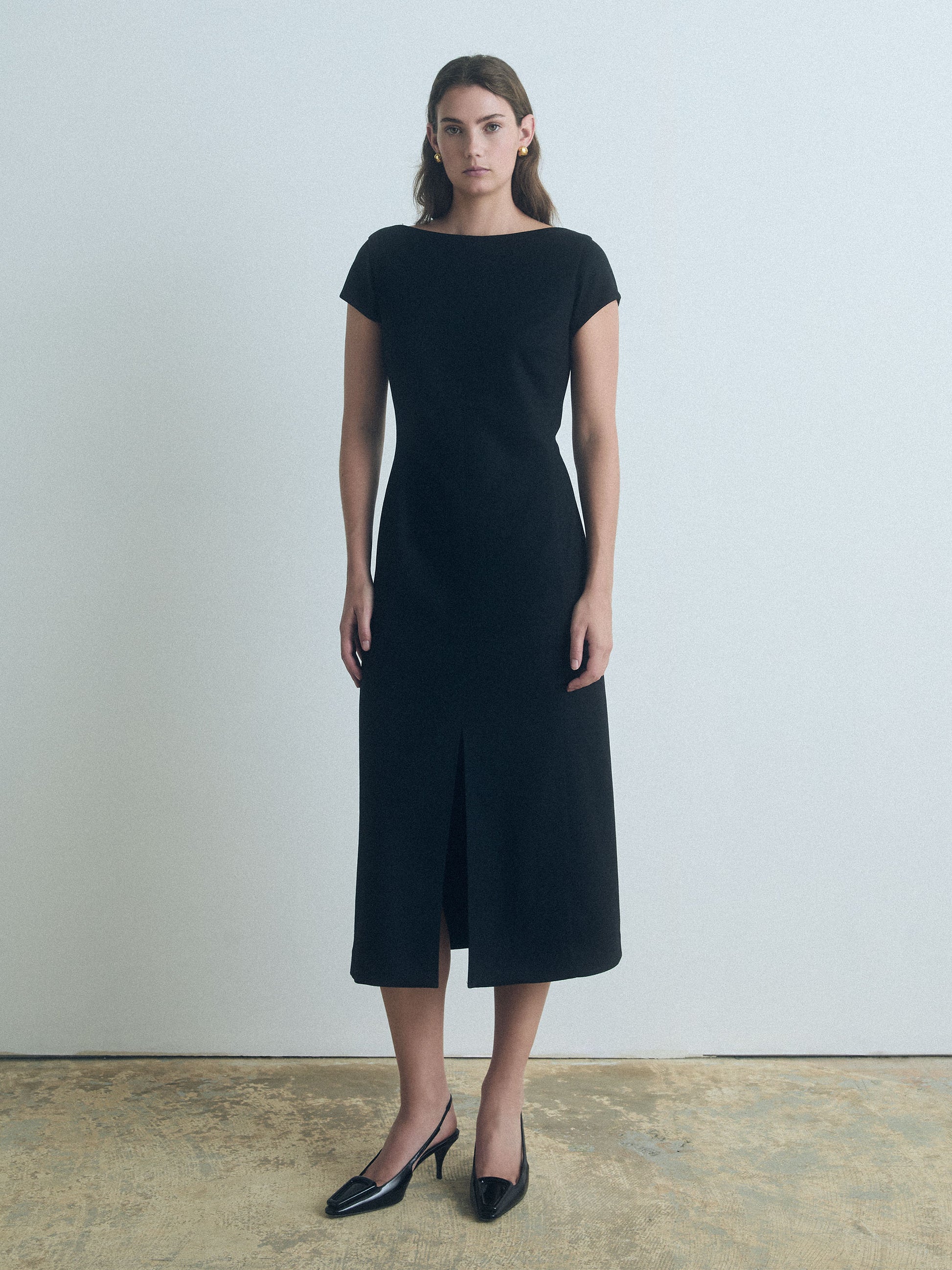 Black wool-blend boat neck dress with front slit and invisible back zipper, fully lined, made in Canada from Italian fabric by Judith & Charles.