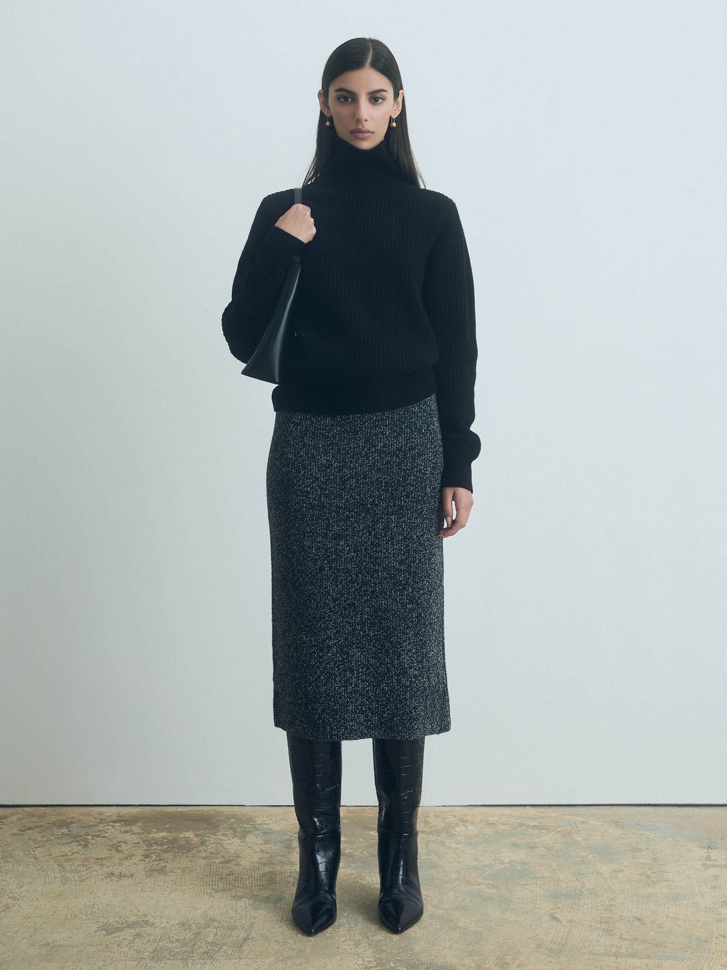 Woman wearing a black turtleneck sweater and straight pull-on skirt in mouline wool, 100% extrafine Italian wool, elastic waist, Selly Skirt by Judith and Charles