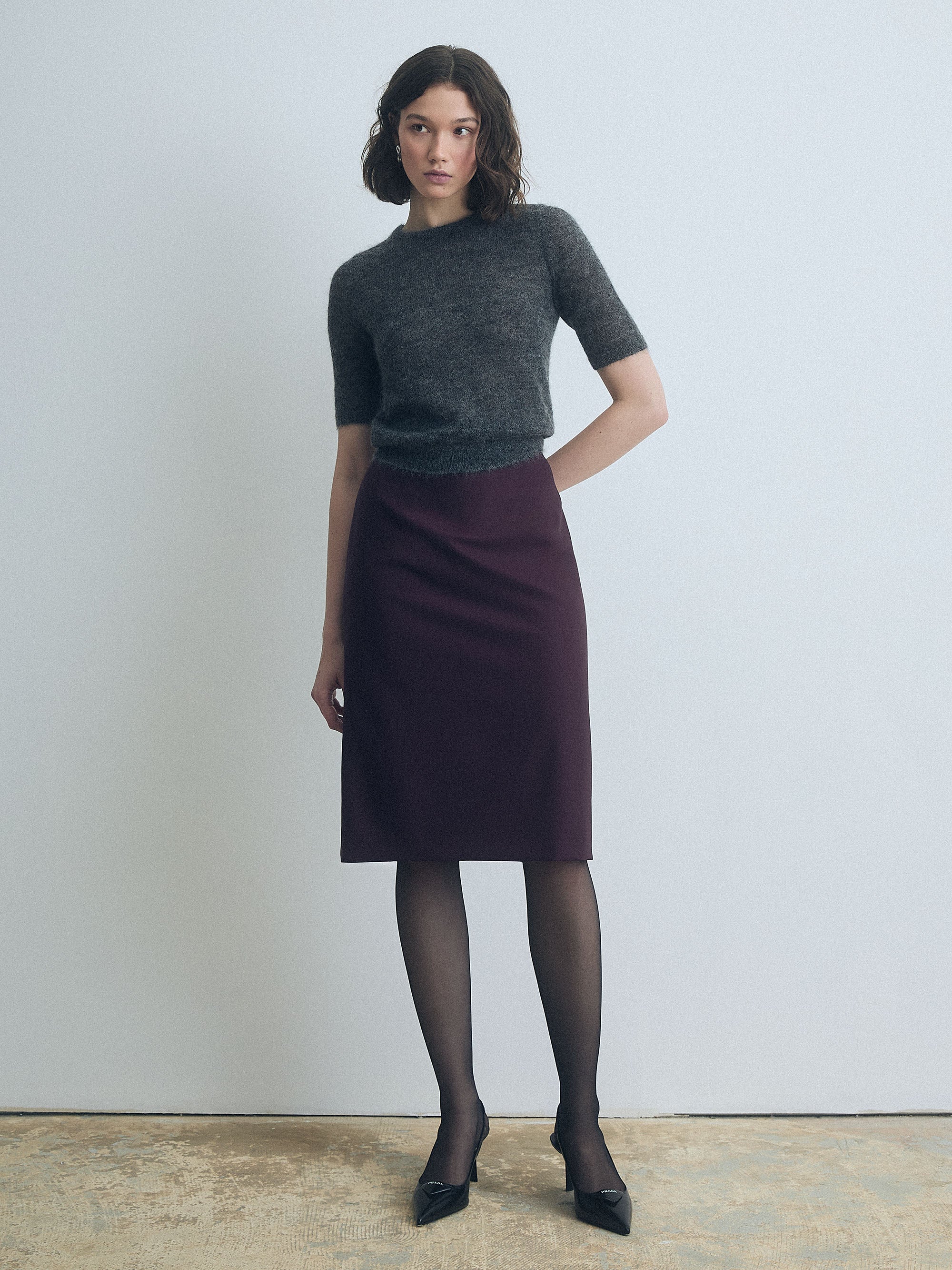 Woman wearing a grey cropped mohair pullover with crew neck by Judith & Charles.