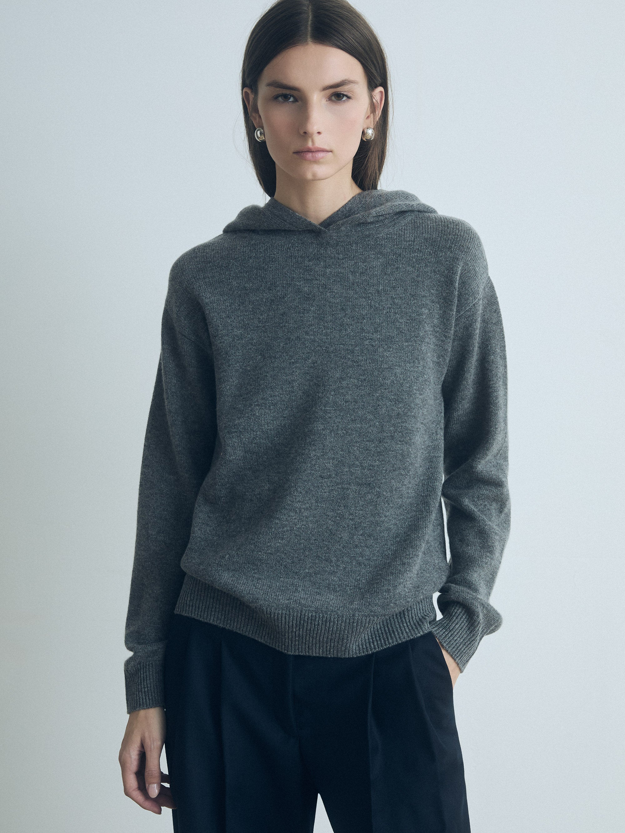 Model wearing Judith & Charles long-sleeve hooded sweater in grey melange Italian merino-cashmere, featuring a relaxed true-to-size fit.