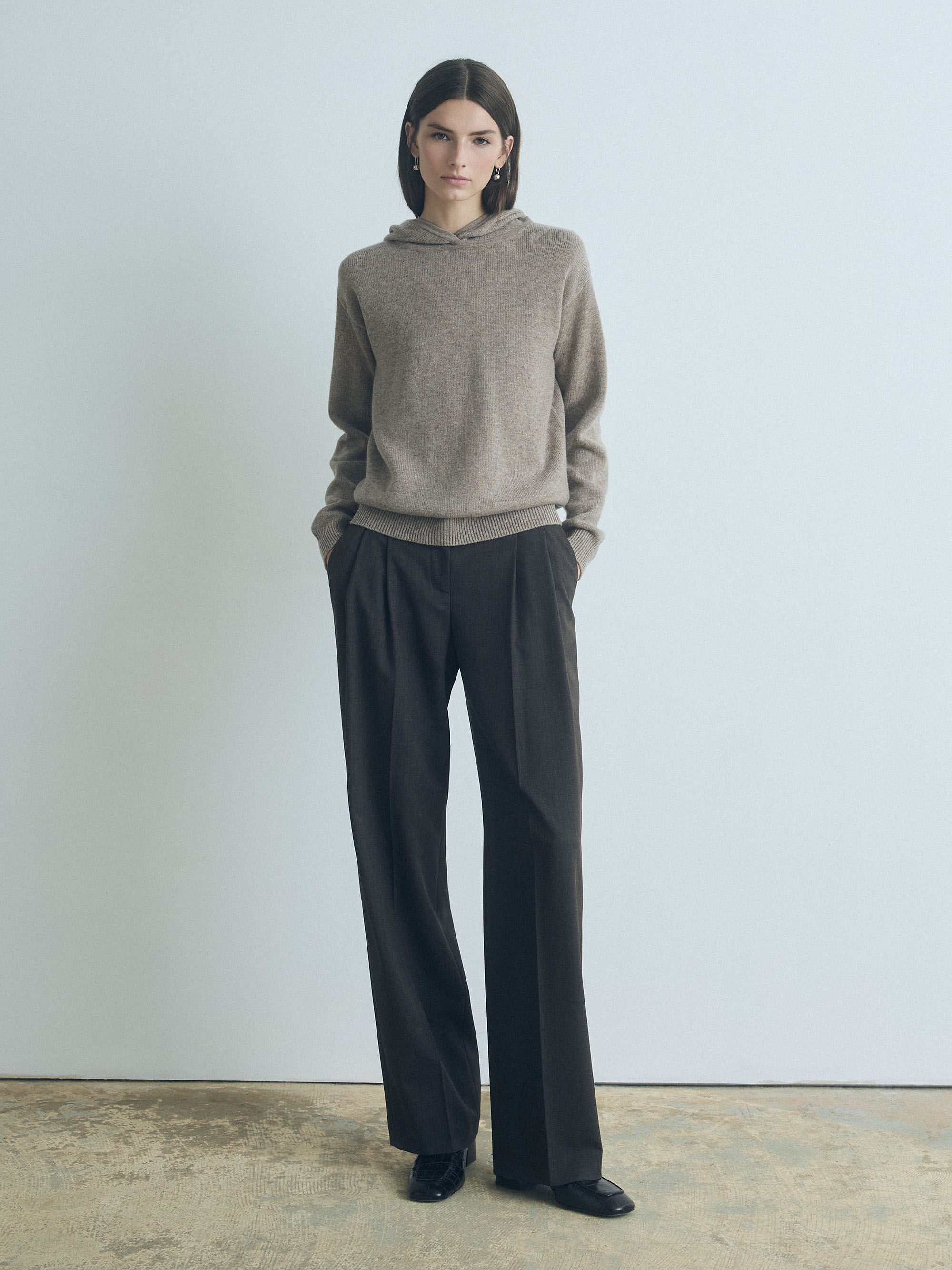 Model wearing Judith & Charles long-sleeve hooded sweater in taupe melange Italian merino-cashmere, featuring a relaxed true-to-size fit.