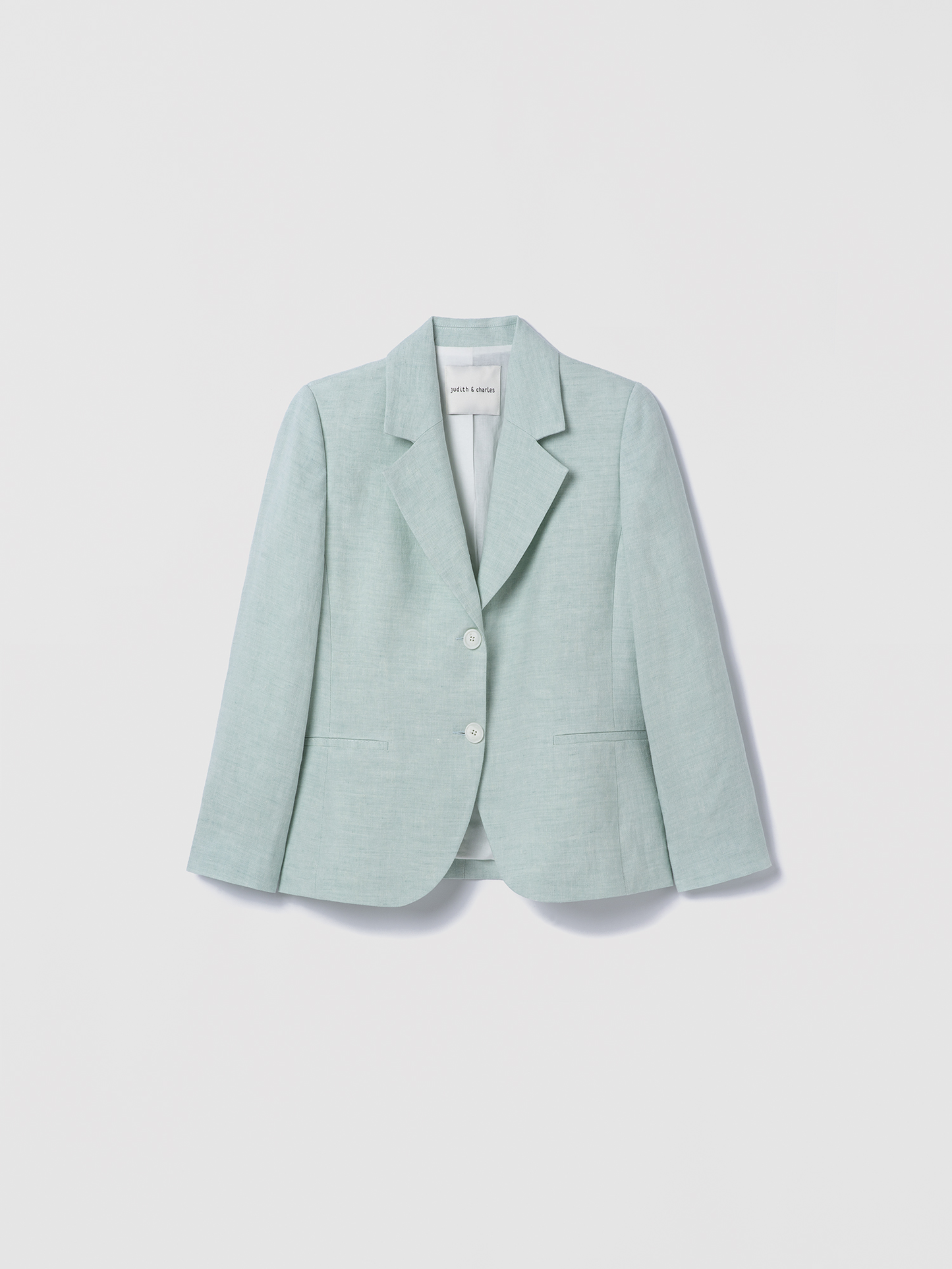 Light green blazer on a light gray background
