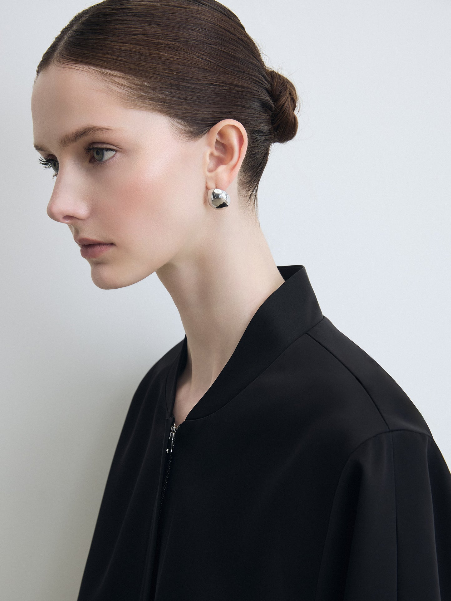 Woman wearing a black outfit with a plain background