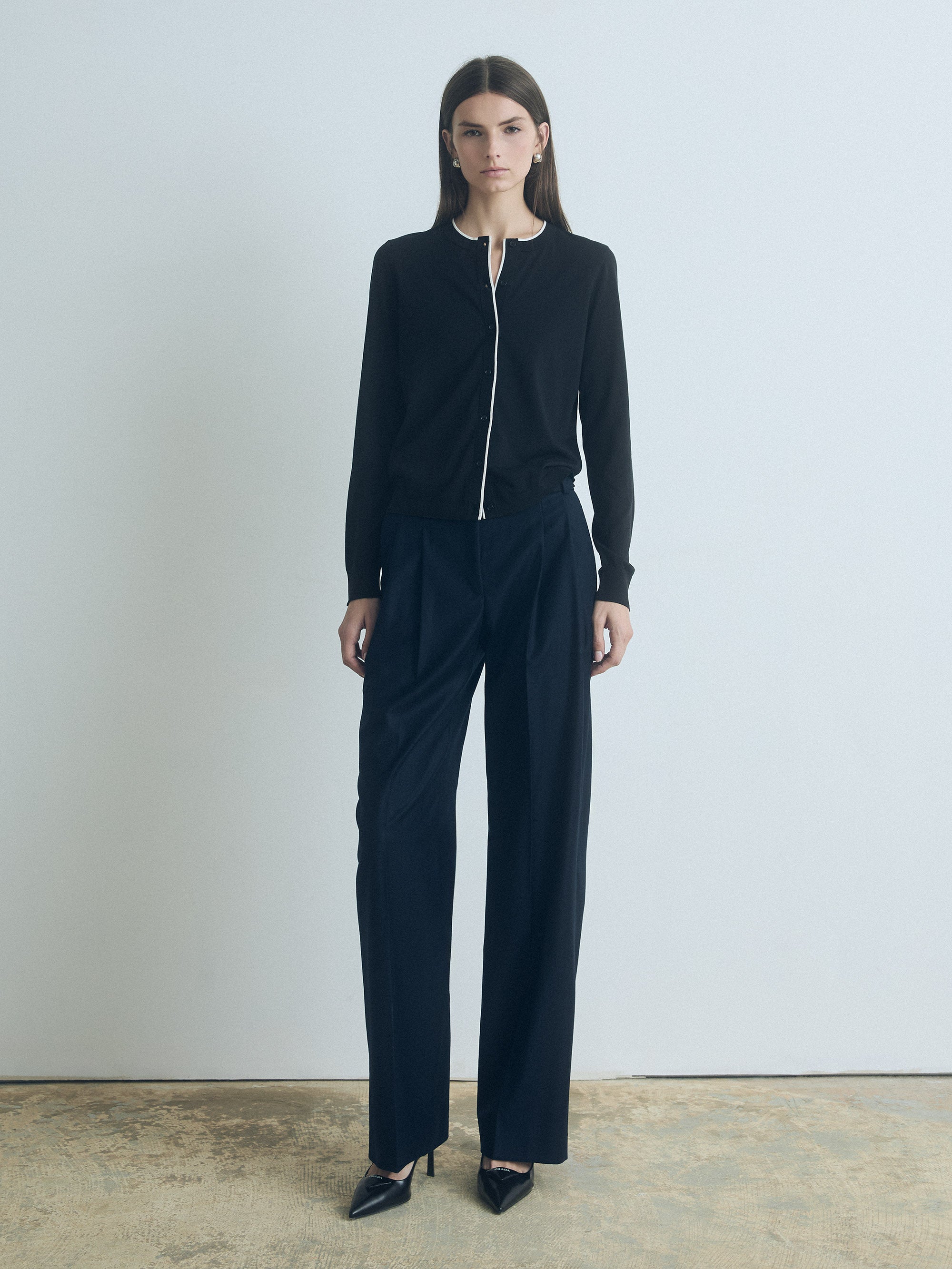 Woman wearing a navy pant with a white background