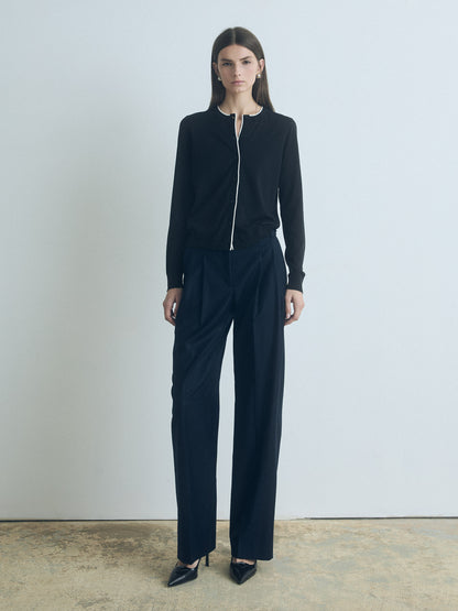 Woman wearing a black outfit with a white background