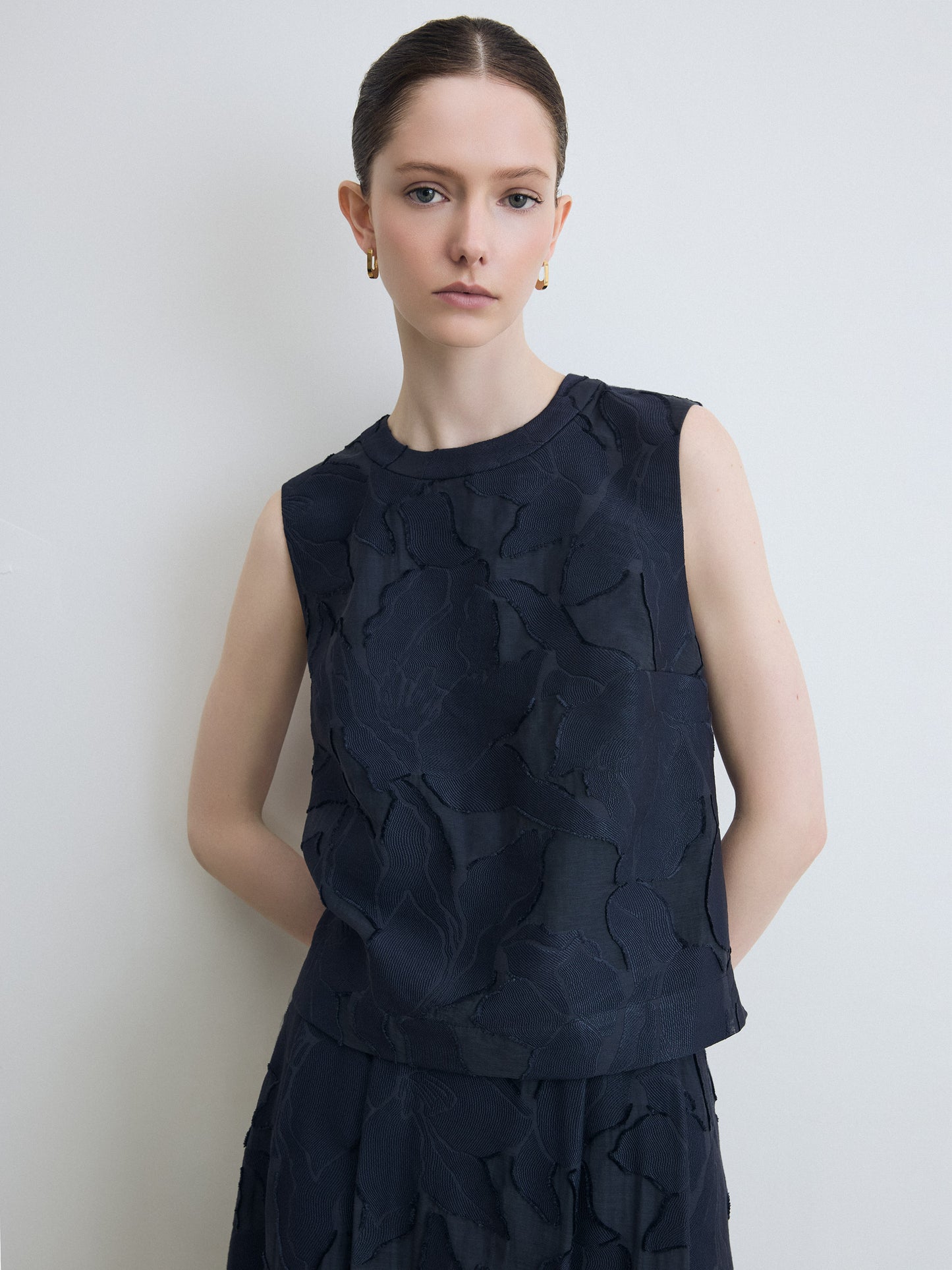 Model wearing navy lace top