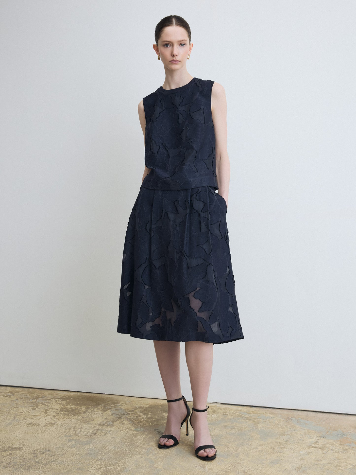 Model wearing navy lace top