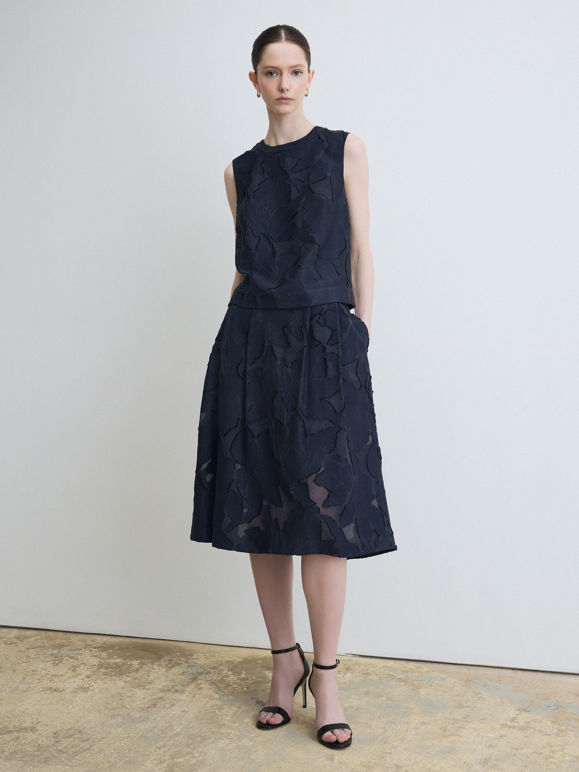 Model wearing navy lace top