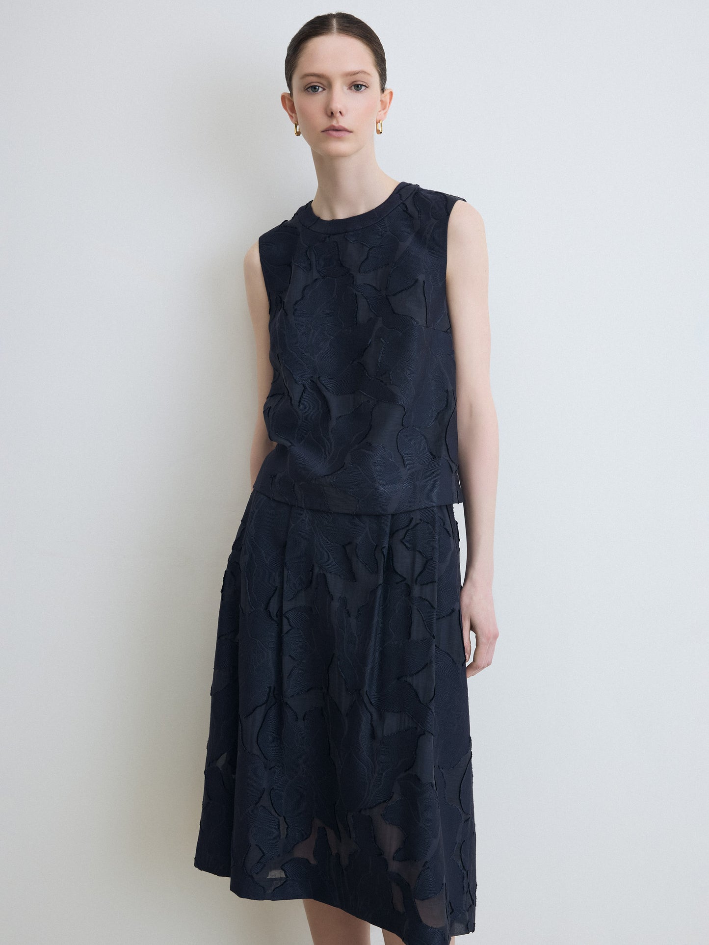 Model wearing navy lace top