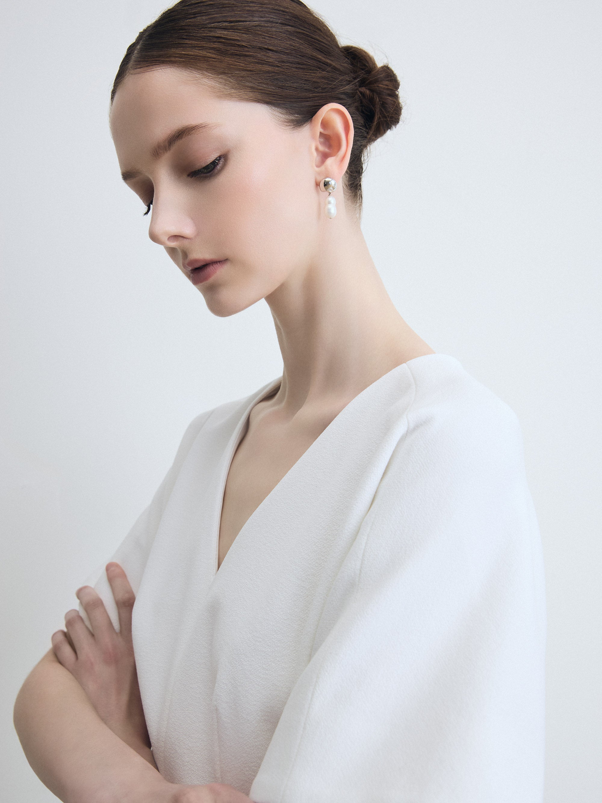 Woman wearing a white dress with a plain background