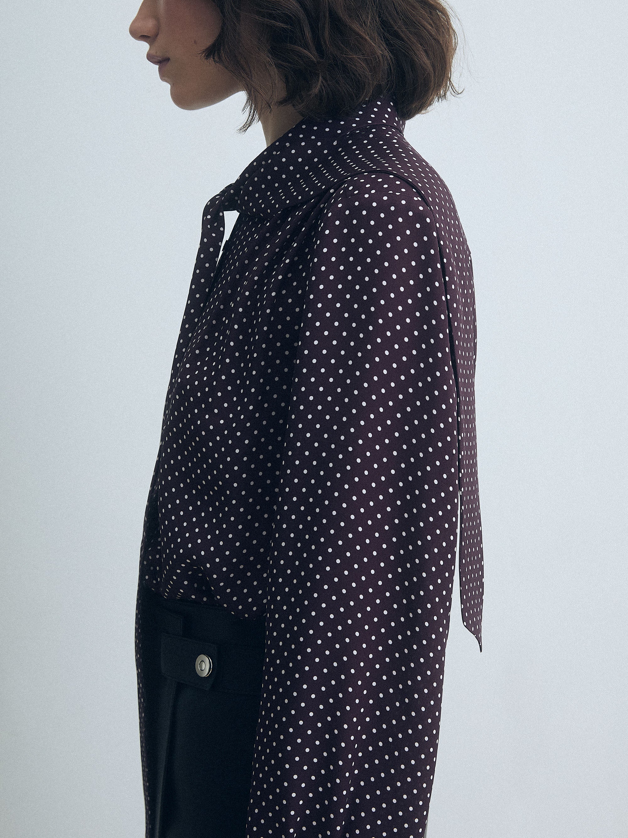Dark cherry dot pleated silk blouse by Judith & Charles, featuring long sleeves, neck tie, button closure, and a straight fit