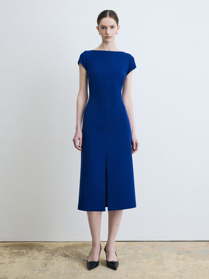 Woman wearing a blue dress against a plain background