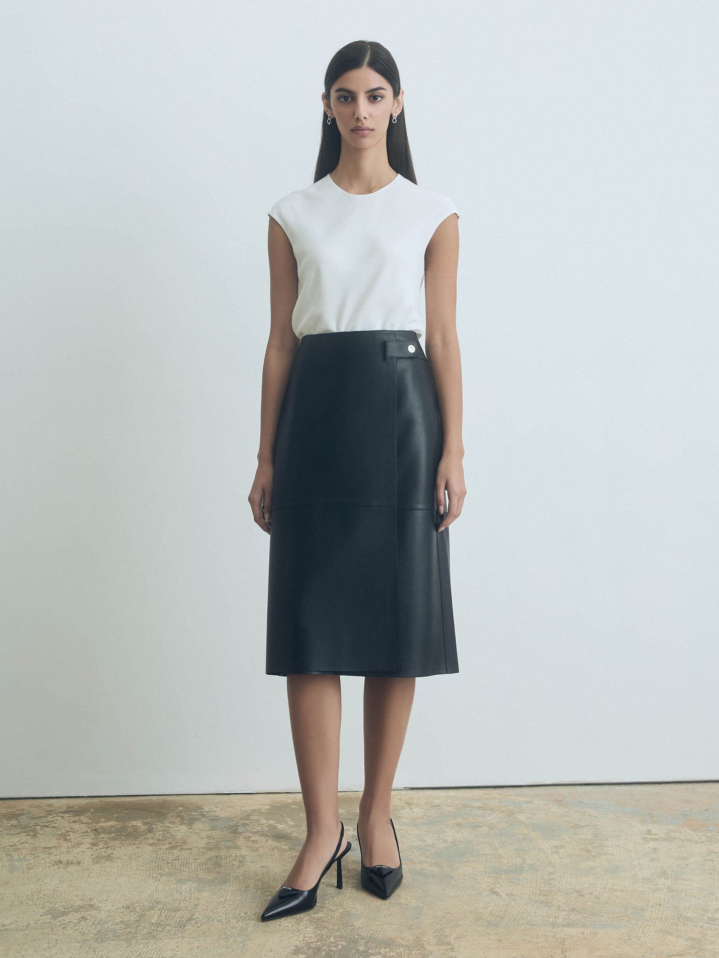 Woman wearing Judith & Charles white silk crew neck top — double-layer front, bias cut, back keyhole with button.