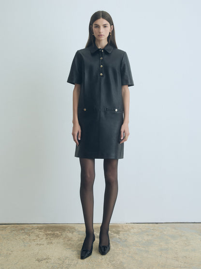 Model wearing Judith and Charles Black leather short sleeve polo dress with spread collar and welt pockets 
