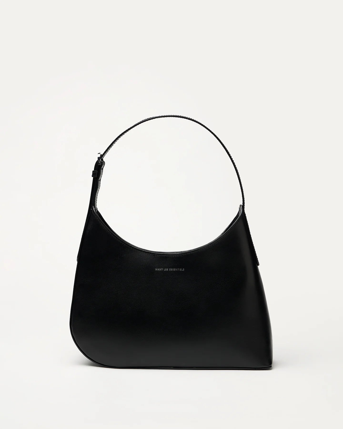 Judith & Charles — Want Les Essentiels black leather shoulder bag with sculpted silhouette, smooth finish, and minimalist design