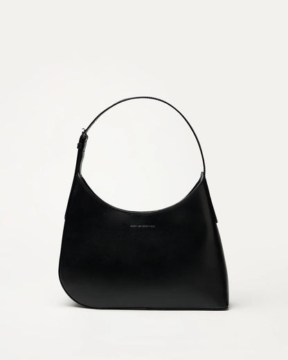Judith & Charles — Want Les Essentiels black leather shoulder bag with sculpted silhouette, smooth finish, and minimalist design