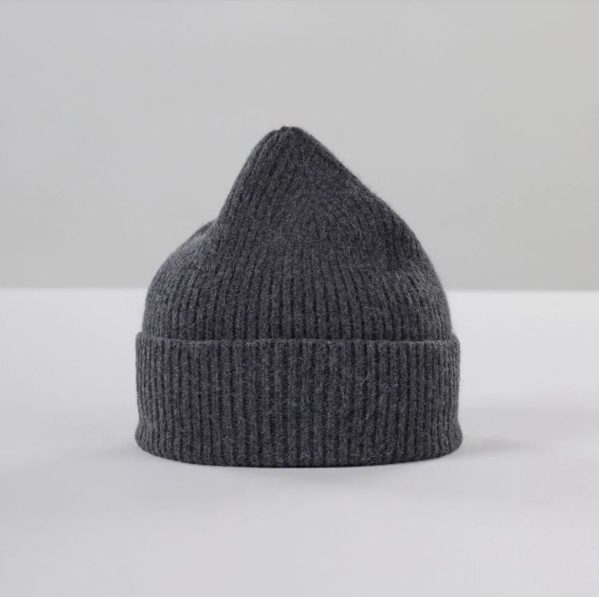 Flat lay of ribbed graphite beanie in soft lambswool and Caregora blend, classic silhouette in wool knit, made in Scotland