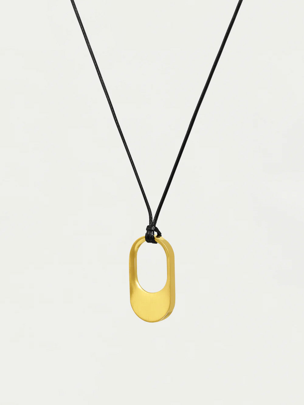 Gold pendant necklace on a black cord against a white background