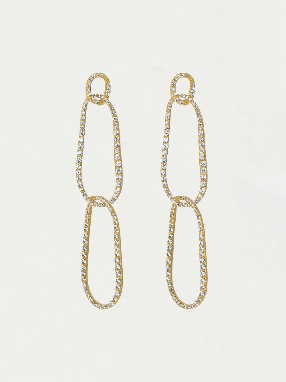 Gold chain earrings with clear gemstones on a light gray background