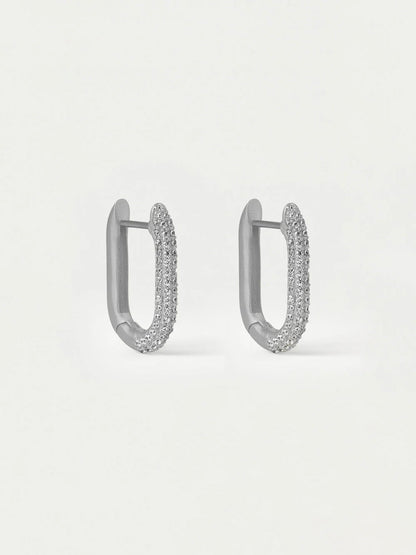 Pair of silver hoop earrings with embedded stones on a light gray background
