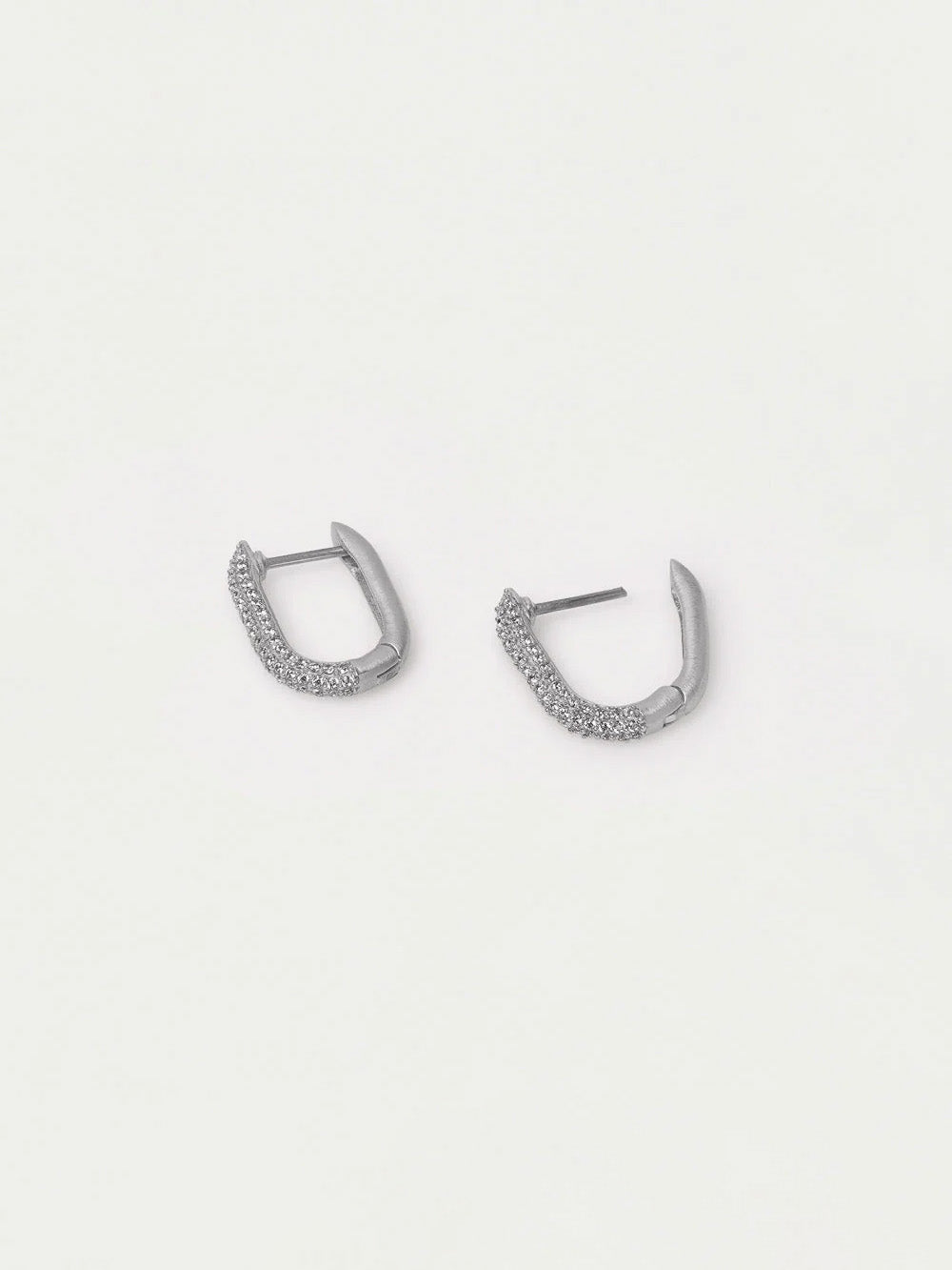 Pair of silver hoop earrings on a light gray background