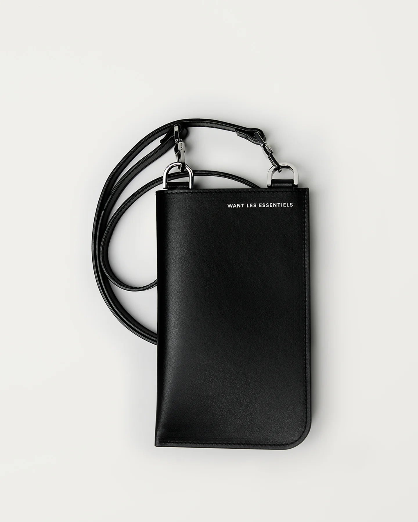 Judith & Charles — Want Les Essentiels  
Smooth leather crossbody bag with detachable strap, card slots, and clutch-like design, ideal for carrying a phone and essentials.