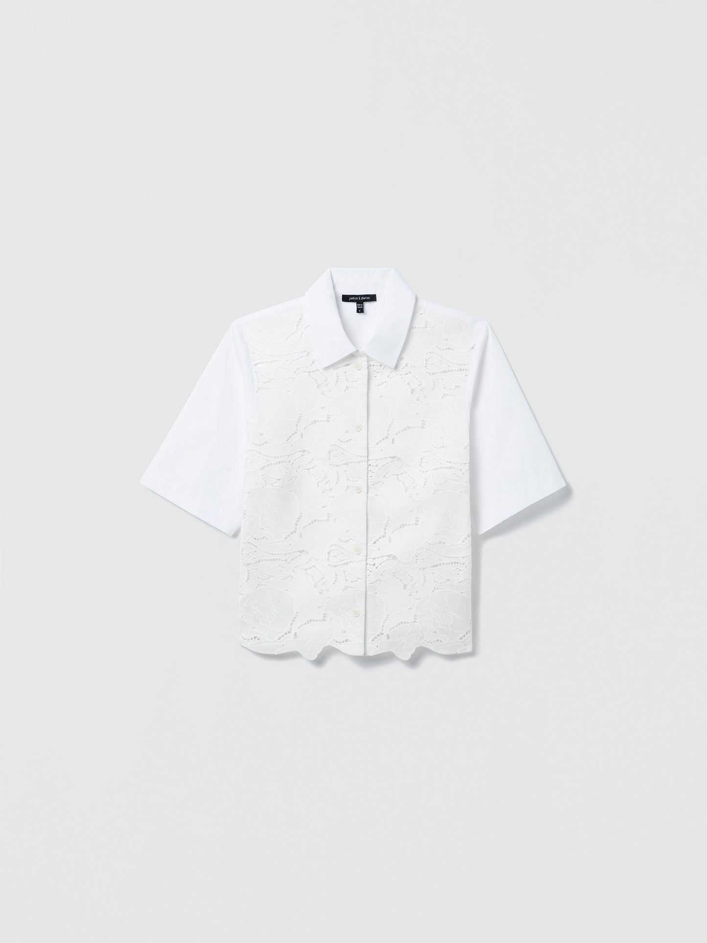 White short-sleeve floral laced blouse on a light gray background