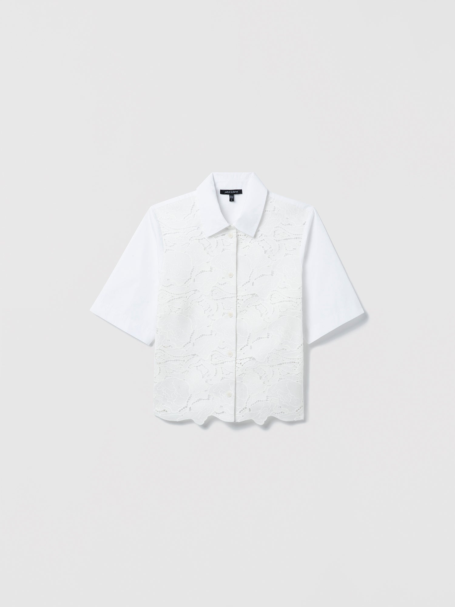 White short-sleeve floral laced blouse on a light gray background