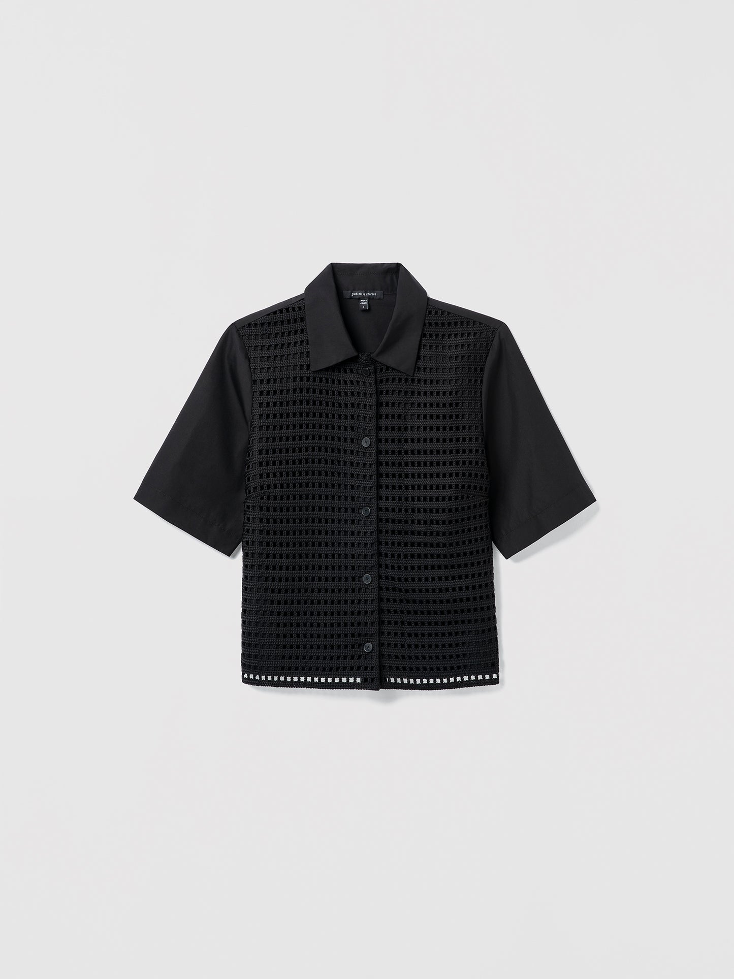 Black textured shirt on a light gray background