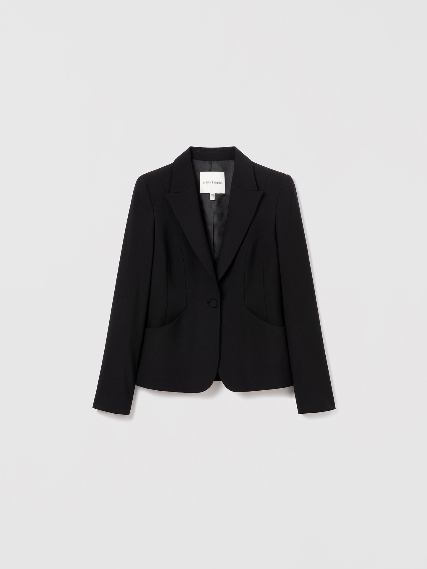 Black single-breasted wool jacket by Judith & Charles, fully lined with a tailored fit. Made from stretch virgin wool with a viscose lining.