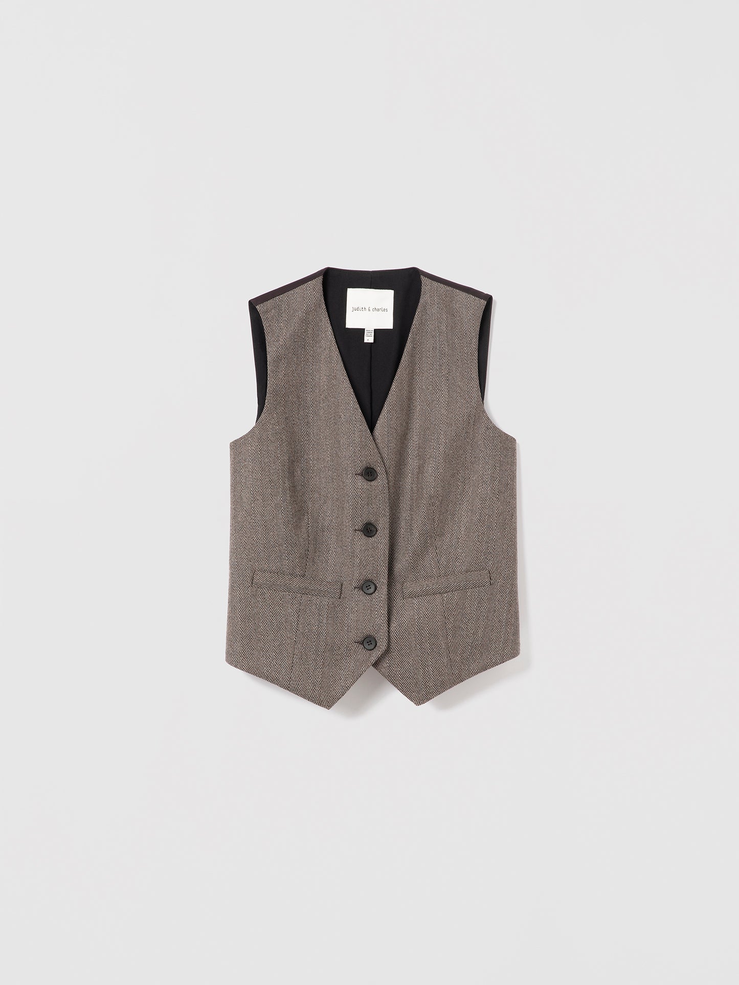 Taupe sleeveless tailored herringbone flannel vest by Judith & Charles, featuring welt pockets and a satin back.