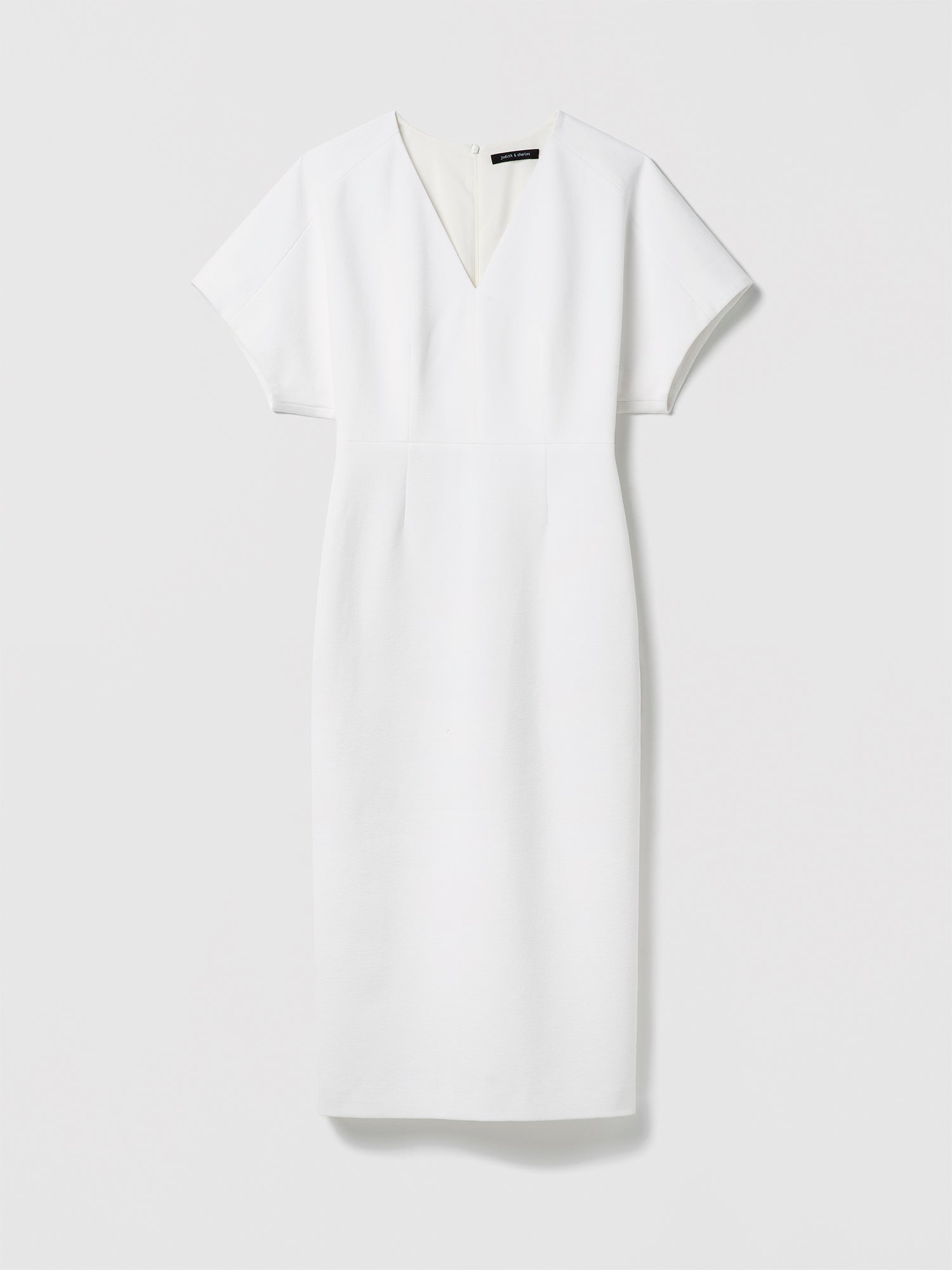 White dress with a V-neckline on a light gray background