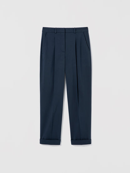 Flat‑lay of Navy pleated cuffed trousers with slash pockets, welt pockets, and a clean tailored waistband.