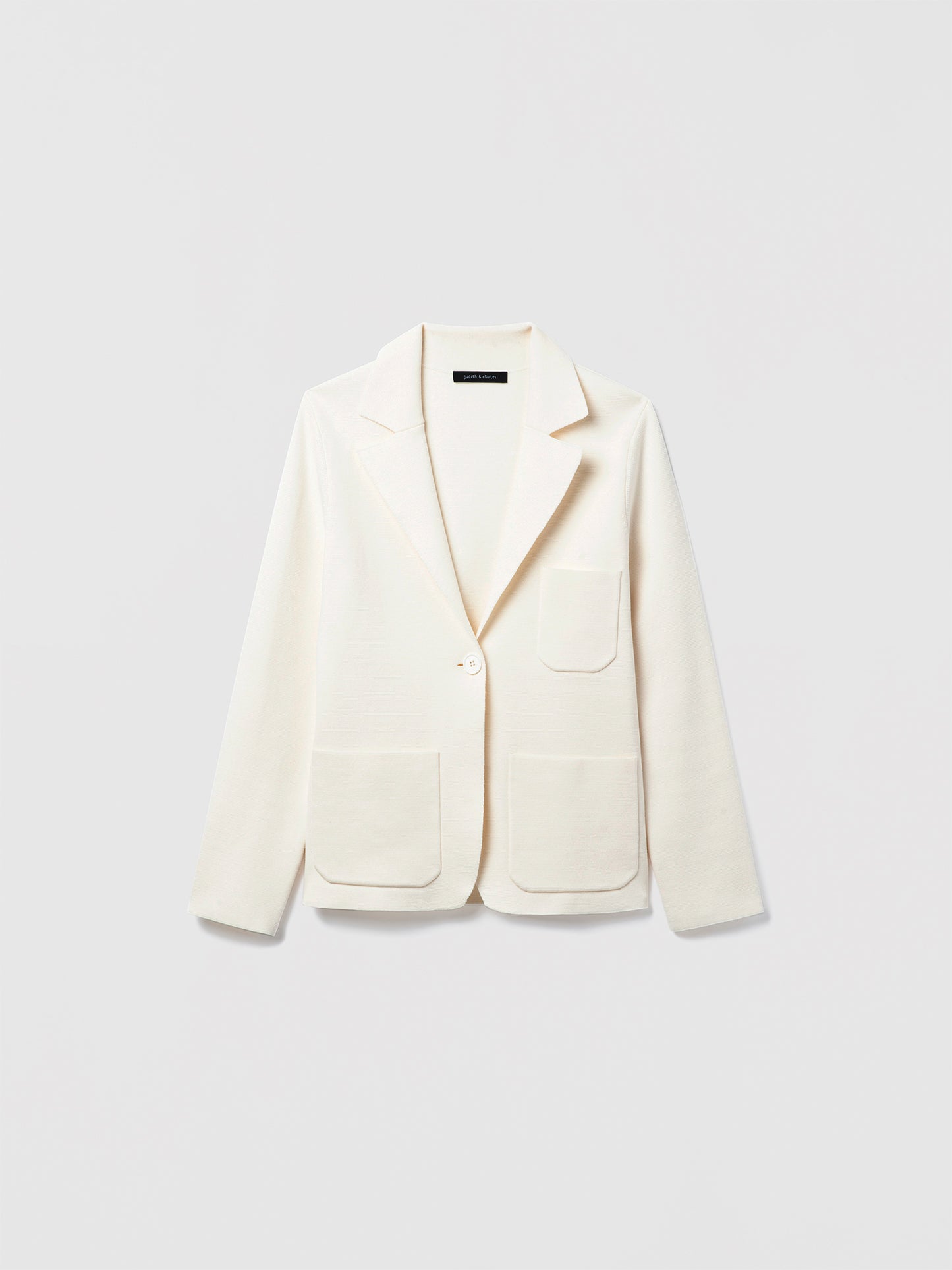 Judith and Charles Off-White Atticus Jacket – Semi-fitted, one-button knit jacket in 100% mercerized cotton with notch lapel, patch pockets, chest pocket, and 24.5″ back length; made from Italian fabric.